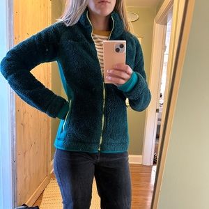 Columbia shaggy green jacket with contrasting neon zippers.